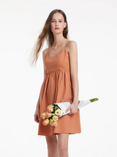 a lady in A-Line spaghetti strap mini dress